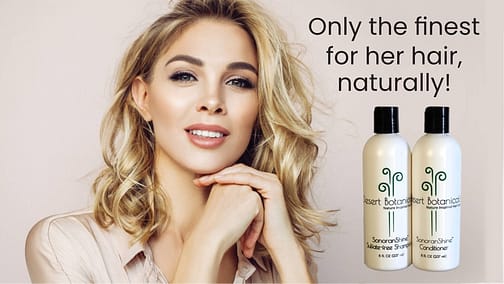Beautiful blonde woman with bottles of Desert Botanicals sulfate-free shampoo and conditioner