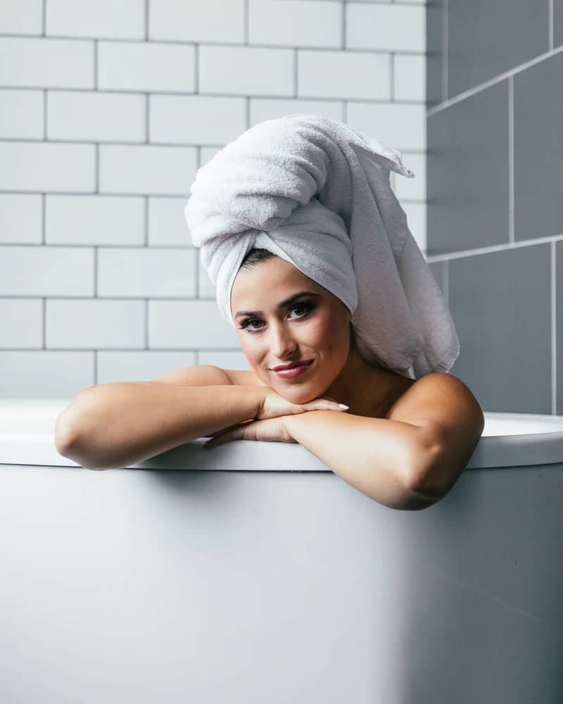 Woman in Bathtub with towel wrapped on head